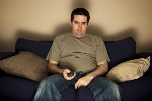 Bored, Overweight Man Sits On The Sofa